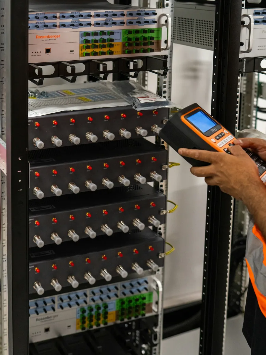 Technician validating a patch panel with a tester